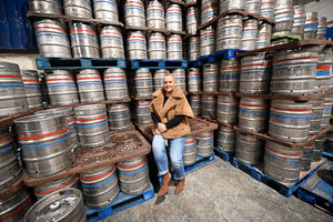 Associate Marketing Director Katie McPhilimey shows off some of the kegs that carry Davenports beer around the region

