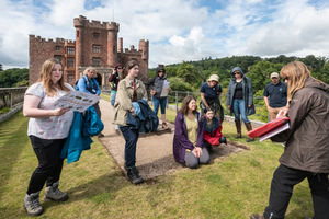 Visitors on a guided tour of the castle and excavations during the Festival of Archaeology 2023 at Powis Castle and Garden, Wales.