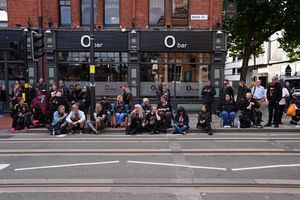 Fans sit patiently waiting to say a final farewell to the rock legend 