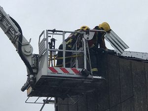 Firefighters working to secure a building in Wolverhampton during the wet and windy weather on Friday. Picture: Martyn Wulfran