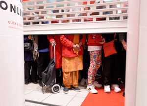 Shoppers waiting for the shutters to rise