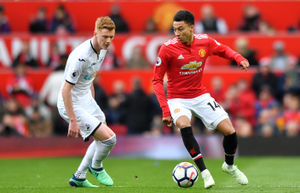 Sam Clucas (left) playing for Swansea City and former Manchester United midfielder Jesse Lingard. Picture: PA