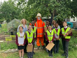 Students of SS Peter and Paul Academy with one of the scarecrows