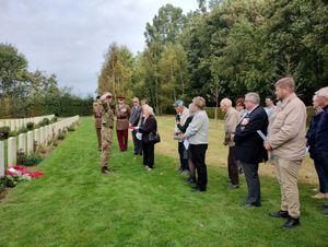 Guardsman Ryan Day of 1st Battalion The Coldstream Guards, presents a Union Flag to Shirley Steeples, the sister of Trooper Cheshire