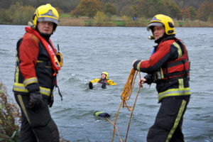 A wounded passenger is rescued from the lake