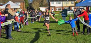 Mark Dalkins is first through the finish line