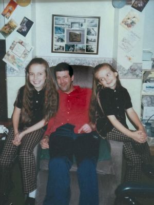 Emily (right), with her dad Laurence, and big sister Jessica.