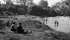 If the weather was warm, outdoor play was a must: cooling off and paddling in the Mere, Ellesmere, in 1949, with Ellesmere Church in the background. Picture courtesy of the Geoff Charles Collection, National Library of Wales.