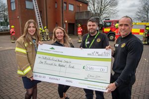 Darcy Schofield (L) from DWH presenting the cheque to Staffordshire Fire and Rescue Service