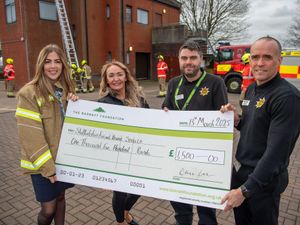 Darcy Schofield (L) from DWH presenting the cheque to Staffordshire Fire and Rescue Service