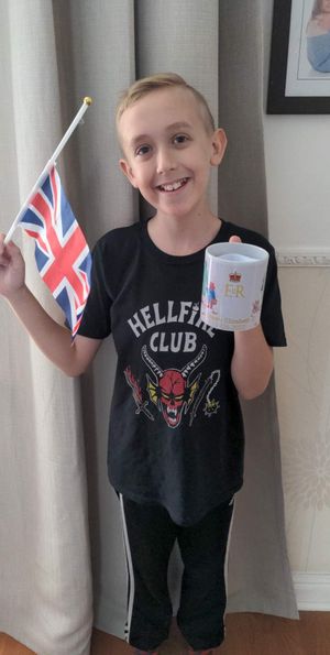 Harry Parker with one of the mugs delivered by Simon and Myles. Photo: Michelle Parker