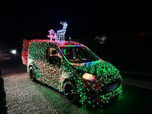 A small van completely covered in lights at the event