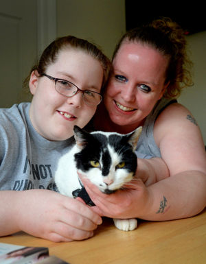 Sam Green and daughter Aaliyah with Porky the cat 
