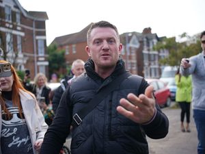 Tommy Robinson in the street in Folkestone surrounded by photographers