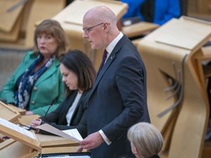 John Swinney speaking in the Scottish Parliament chamber