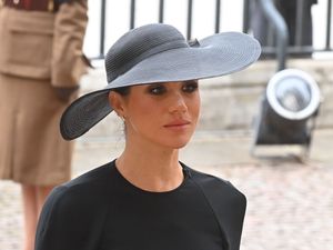 Meghan in a wide brimmed hat at Queen Elizabeth II's funeral