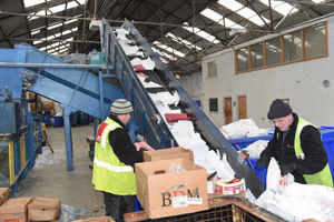 WN Security Shreddings Shifnal. Manager Peter Busby and Factory Operative Christopher Richards load waste paper onto a conveyer belt to be shredded.