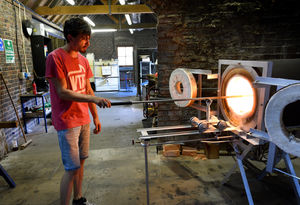 Glass blower Ryan Ashcroft working in the heat at the Red House Glass Cone