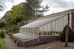 The historic Kitchen Walled Garden greenhouse at Benthall Hall has been recreated by White Cottage Greenhouses.