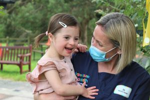 Amelia having a cuddle with Hope House nurse Jo Boden