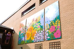 Compton Care chair of the Board of Trustees Ros Keeton poses with local artist Charlotte Webb next to the mural