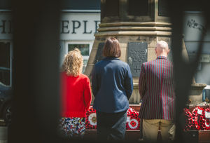 Tim and Helen from the Uttoxeter RBL and Taylor Wimpey's Sales Executive Emma photographed following a donation from the housebuilder for VE Day 80