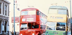 A Midland Red motorbus overtakes a green-and-yellow Wolverhampton trolleybus