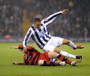 Jerome Thomas is challenged by Peter Ramage.