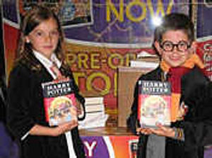 Josh Stork, nine, from Newport and Mattie Lefevre, 10, from Shrewsbury were cheered on by the crowds as they officially  ripped open the first two boxes of the Deathly Hallows to arrive at WHSmith at exactly 12.01am.