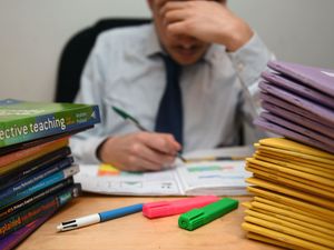 Teacher marking papers