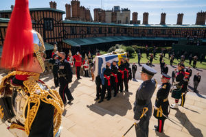 The Duke of Edinburgh's coffin, covered with his Personal Standard, is carried into St George's Chapel