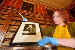 Conservation assistant Laura Turner in the library looking after a picture of Thomas Henry Noel-Hill
