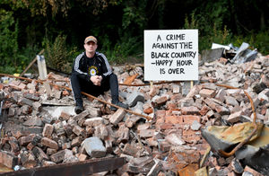Artist Dion Kitson painted the signs erected in the rubble at the Crooked House 