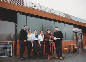 Franchisee Ash Raju, together with HRH Maha Putri Maria Amor Leonora Torres Mastura and Penn Road McDonald's crew members. 