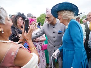 Camilla speaks to guests during a garden party at Buckingham Palace