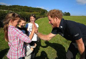 High five! Prince Harry meets young admirers during the walk in Shropshire. Photo by Chris Jackson/Getty Images