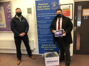 Pave Aways’ construction director Jamie Evans (left) hands over the tablets to Rob Edwards, head teacher at Newtown High School