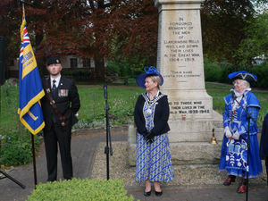 Standard bearer Rhodri Evans, Llandrindod Wells Mayor Councillor Marcia Morgan and Town Crier Jan Swindale at the town's war memorial