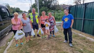 Dave hands supplies to grateful residents in Ukraine   