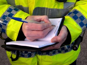 Police officer writing in notebook