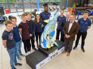 Supporting image for story: Wolf statue is new leader of university racing pack