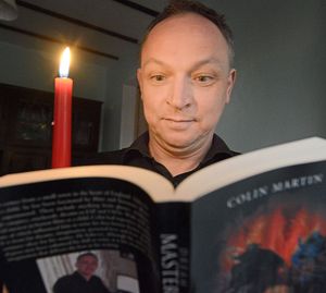 Thrills and spills – horror writer Colin with one of his books