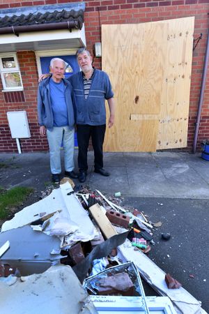 Fred and John outside the home which is 'beyond repair' according to John