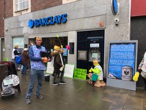 Supporting image for story: 'Dirty scrubbers' clean Oswestry bank in fossil fuel protest
