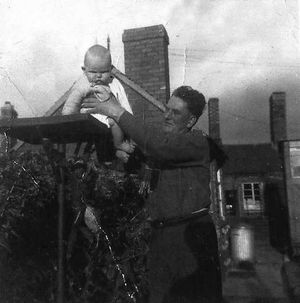 Josie's baby brother Glyn Downes and dad Joe at The Old Yard in 1954.