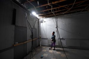 Chair Rebecca Spittle inside the centre looking at the fire-damaged roof. Photo: Tim Sturgess