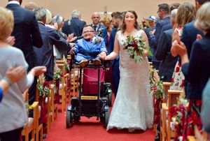 Smiles as the happy couple go down the aisle