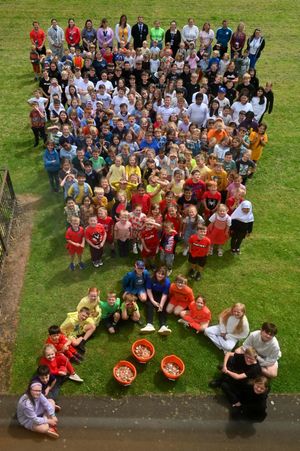 The children create a mini rainbow to celebrate their fundraising efforts