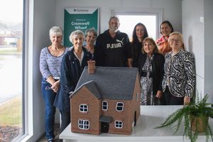Members of Lichfield Machine Knitting Club present the model home to Elaine Brown, Sales Director at Persimmon Homes West Midlands