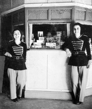 Staff at the Grand cinema, Wellington, in 1938. The page in the scrapbook gives the caption: 'Pat Ford and Mary Taylor.' Also the 1938 date. It also appears in a memories booklet captions: 'Pat and Mary, two members of the Grand staff in the thirties, by the combined sales kiosk and pay box.' This picture was shared by Mrs Lynne Purcell, and is another from the collection of her late father Fred Brown.
